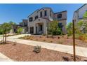 Two-story house with gray siding, brown garage door, and landscaping at 19743 W Exeter Blvd, Buckeye, AZ 85340