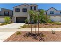 Two-story house with gray siding, brown garage door, and landscaping at 19743 W Exeter Blvd, Buckeye, AZ 85340
