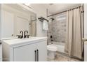 Updated bathroom with white vanity, gray tile, and bathtub at 4442 E Walatowa St, Phoenix, AZ 85044