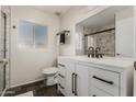 Modern bathroom with a white vanity, black accents, and a large shower at 4442 E Walatowa St, Phoenix, AZ 85044