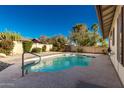 Inviting swimming pool with a concrete deck and surrounding landscaping at 4442 E Walatowa St, Phoenix, AZ 85044
