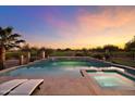 Relaxing pool and spa with a serene view of the golf course at sunset at 7735 E Hartford Dr, Scottsdale, AZ 85255