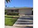 Front view of a single-story home with a beige garage door at 10103 W Forrester Dr, Sun City, AZ 85351