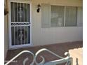 Home's entrance with a security door and tiled flooring at 10103 W Forrester Dr, Sun City, AZ 85351