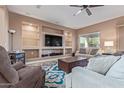 Spacious living room with built-in shelving and a large TV at 1864 W Buckhorn Trl, Phoenix, AZ 85085
