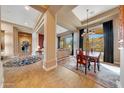 Elegant dining room with chandelier and views of the desert landscape at 24686 N 120Th Pl, Scottsdale, AZ 85255