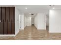 Modern hallway with tile floors and wood accent wall at 6306 W Mitchell Dr, Phoenix, AZ 85033