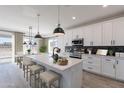 Spacious kitchen featuring white cabinets and large island at 927 N 97Th Way, Mesa, AZ 85207