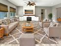 Spacious living room with fireplace, built-in shelving, and large windows at 14139 W Gray Fox Trl, Surprise, AZ 85387