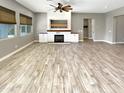 Open living area with hardwood floors and a fireplace at 14139 W Gray Fox Trl, Surprise, AZ 85387