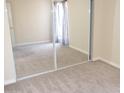 Simple bedroom with mirrored closet doors and neutral carpeting at 3434 W Danbury Dr # A204, Phoenix, AZ 85053