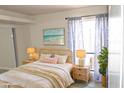 Bedroom with wicker furniture and beach-themed art at 3434 W Danbury Dr # A204, Phoenix, AZ 85053