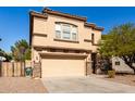 Two-story house with beige exterior, stone accents, and a large driveway at 664 W Viola St, Casa Grande, AZ 85122