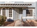 Front entrance of a townhome with gray exterior and wrought iron door at 860 N Mcqueen Rd # 1178, Chandler, AZ 85225