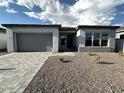 New construction home showcasing clean lines and attractive gray exterior at 11512 E Utah Ave, Mesa, AZ 85212