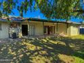 Covered patio and spacious backyard with grassy area at 1311 E 2Nd Pl, Mesa, AZ 85203