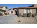 Single story home with front yard landscaping and a two car garage at 15668 W Devonshire Ave, Goodyear, AZ 85395