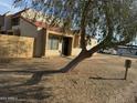 Tan stucco condo with tile roof and wooden fence at 4766 W Rose Ln, Glendale, AZ 85301
