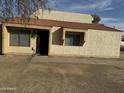 Tan stucco condo with tile roof and a walkway to the entrance at 4766 W Rose Ln, Glendale, AZ 85301