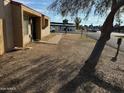 Tan stucco condo with tile roof and walkway, next to a tree at 4766 W Rose Ln, Glendale, AZ 85301