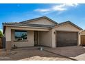 New construction home with a brown garage door and paved driveway at 9307 W Jefferson St, Tolleson, AZ 85353