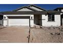 Newly constructed single story home with white exterior and a two-car garage at 17504 W Lupine Ave, Goodyear, AZ 85338