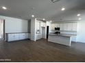 Modern kitchen with white cabinets, gray countertops, and an island at 17504 W Lupine Ave, Goodyear, AZ 85338