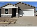 New construction home features a two-car garage and stone accents at 1978 E Parr Fame Ln, San Tan Valley, AZ 85140