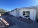 Updated single-level home with a clean, modern exterior and a paved driveway at 2045 E Birchwood Ave, Mesa, AZ 85204