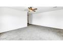 Bright bedroom featuring neutral carpeting and ceiling fan at 25370 W Jackson Ave, Buckeye, AZ 85326