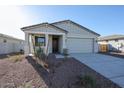 Newly constructed home with two-car garage and desert landscaping at 35595 W Mallorca Ave, Maricopa, AZ 85138