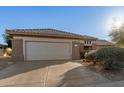 One story home with a two-car garage and desert landscaping at 16319 W Mission Cove Ln, Surprise, AZ 85374