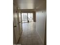 Bright hallway with tile flooring and sliding glass doors leading to a patio at 16822 N Boswell Blvd, Sun City, AZ 85351