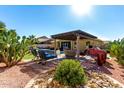Relaxing backyard oasis with a pergola, pool, and patio furniture at 18174 W Wind Song Ave, Goodyear, AZ 85338