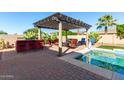 Relaxing patio area with built-in bar and seating, perfect for entertaining at 18174 W Wind Song Ave, Goodyear, AZ 85338