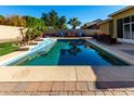 Stunning pool with spacious deck and tranquil water features at 18174 W Wind Song Ave, Goodyear, AZ 85338