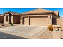 Tan two-car garage home with desert landscaping at 24230 S Desert Vale Dr, Sun Lakes, AZ 85248