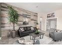 Spacious living room with gray sofas and a wood-look feature wall at 3205 E Gemini Ct, Chandler, AZ 85249