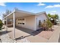 View of the mobile home from the side, showing the carport at 3330 E Main St # 111, Mesa, AZ 85213