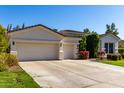 Two-car garage and landscaped front yard with flowering bushes at 4577 S Ambrosia Dr, Chandler, AZ 85248