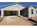 New home under construction, showing unfinished garage and landscaping at 47702 W Cansados Rd, Maricopa, AZ 85139