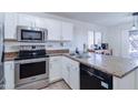 Well-equipped kitchen with stainless steel appliances and white cabinetry at 10856 E Arcadia Ave, Mesa, AZ 85208