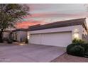 White stucco home with a three-car garage and desert landscaping at 12776 N 114Th St, Scottsdale, AZ 85259