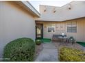 Condo entry with small table, bench and landscaping at 17262 N 105Th Ave, Sun City, AZ 85373