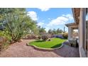 Landscaped backyard with artificial turf and desert plants at 22207 N 51St St, Phoenix, AZ 85054