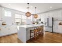 Modern kitchen featuring white cabinets, a large island, and stylish lighting fixtures at 4141 E Pony Ln, Gilbert, AZ 85295