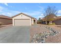 Single-story home with a two-car garage and rock landscaping at 14834 W Calavar Rd, Surprise, AZ 85379
