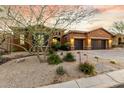 Spanish style home with mature trees and drought-tolerant landscaping at 18394 N 97Th Pl, Scottsdale, AZ 85255