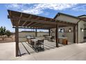 Covered outdoor kitchen and grilling area with seating at 26367 S 231St Way, Queen Creek, AZ 85142