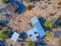 Aerial view of a desert property featuring a home with solar panels at 26956 N Shirley Rd, San Tan Valley, AZ 85143